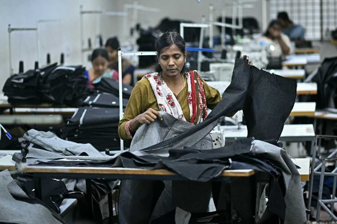 A garment worker tailors clothes on a sewing machine at an apparel manufacturing unit in Bengaluru A garment worker tailors clothes on a sewing machine at an apparel manufacturing unit in Bengaluru