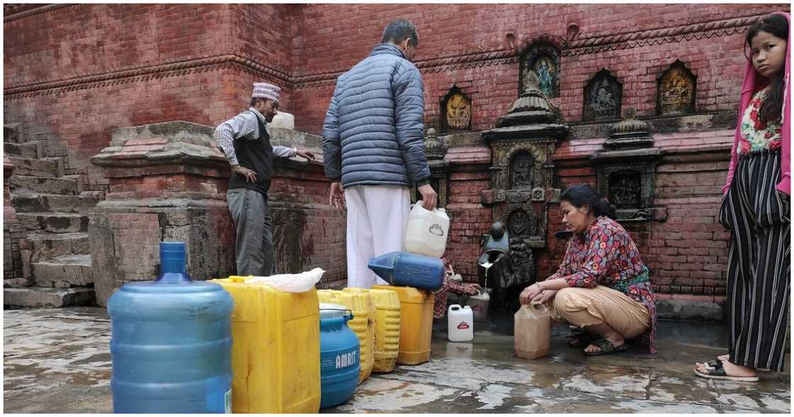 People queuing for water at the Water Fountains of the Kathmandu Valley, Nepal