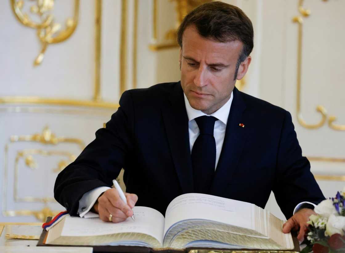 The write stuff: French President Emmanuel Macron signs the Golden Book at Slovakia's presidential palace Tuesday The write stuff: French President Emmanuel Macron signs the Golden Book at Slovakia's presidential palace Tuesday
