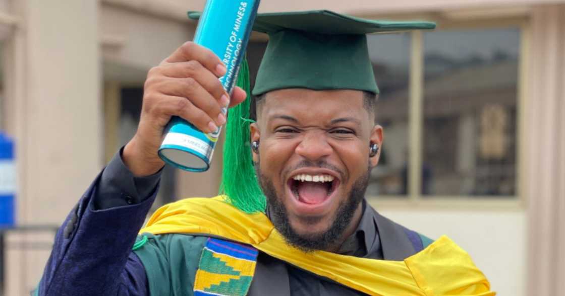 Man beams with smiles as he graduates op of his class