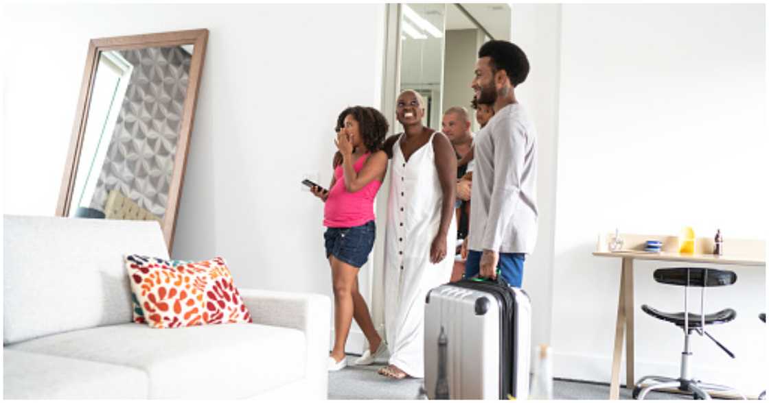 A family is welcomed to their new home by a landlord A family is welcomed to their new home by a landlord