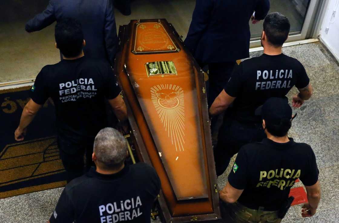 One of the coffins containing human remains found during the search for British journalist Dom Phillips and indigenous expert Bruno Pereira is carried upon arrival at the Federal Police hangar in Brasilia on June 16, 2022 One of the coffins containing human remains found during the search for British journalist Dom Phillips and indigenous expert Bruno Pereira is carried upon arrival at the Federal Police hangar in Brasilia on June 16, 2022