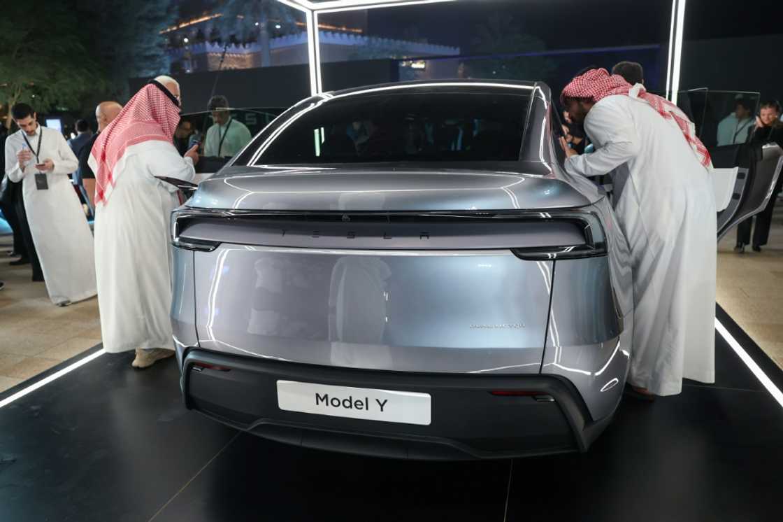 Saudis check a car at the Tesla company's first showroom in Riyadh. Elon Musk's firm has opened three showrooms in oil rich Saudi Arabia