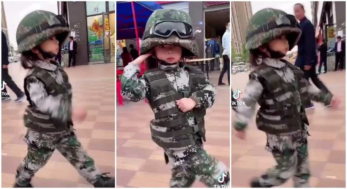 Kid salutes like a smart soldier.