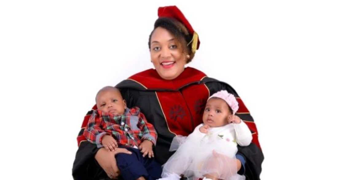 Mother of poses with her twin babies Mother of poses with her twin babies