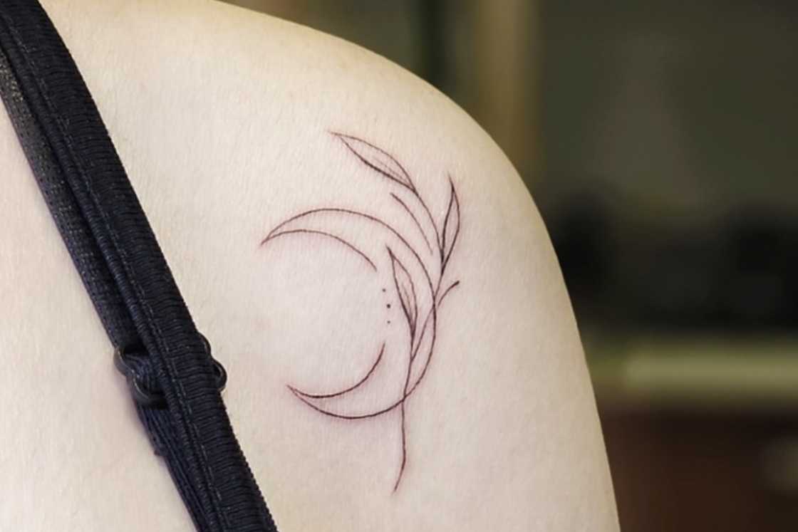 Crescent moon and tree branch front shoulder tattoo Crescent moon and tree branch front shoulder tattoo