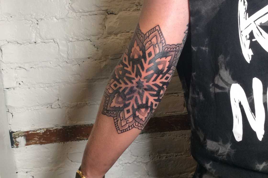 Detailed snowflake elbow tattoo Detailed snowflake elbow tattoo