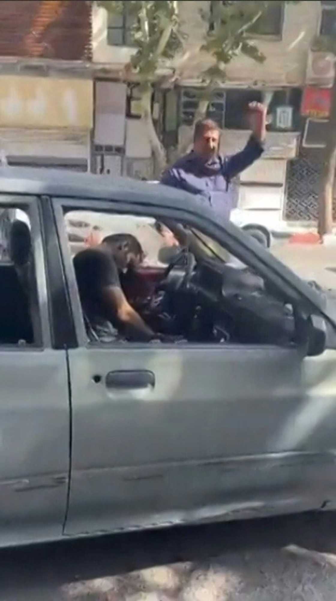 This grab taken from a video posted online on October 8, 2022, shows a driver shot dead in his car in Sanandaj, the capital of Iran's Kurdistan province