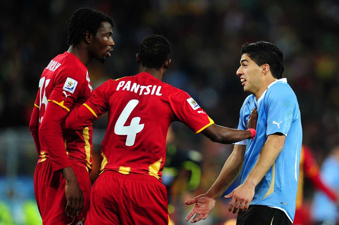 John Pantsil breaks up a disagreement between Isaac Vorsah (L) and Luis Suarez of Uruguay (R) during the 2010 FIFA World Cup South Africa Quarter Final match between Uruguay and Ghana on July 2, 2010 in Johannesburg, South Africa