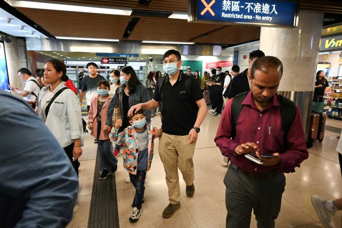 Arrivals from mainland China enter Hong Kong via the Lo Wu border control point on Wednesday Arrivals from mainland China enter Hong Kong via the Lo Wu border control point on Wednesday