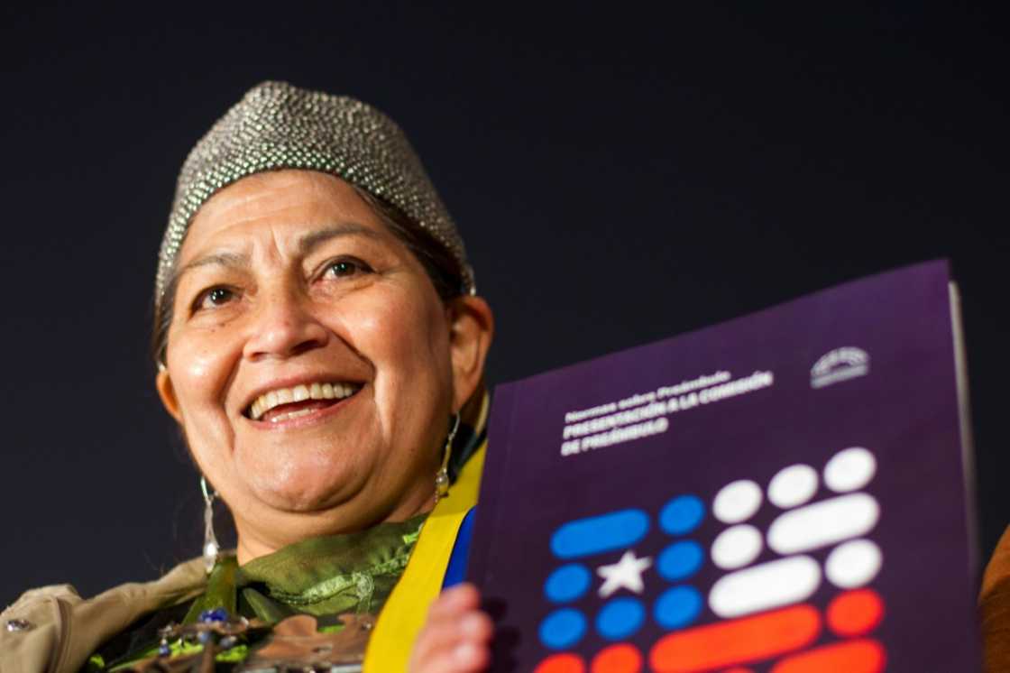 Constitutional Convention member Elisa Loncon displays a copy of the draft of the new Chilean constitution during its official presentation on May 16, 2022 Constitutional Convention member Elisa Loncon displays a copy of the draft of the new Chilean constitution during its official presentation on May 16, 2022