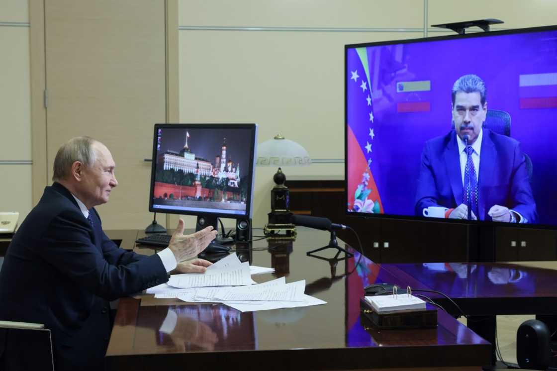 In this pool photograph distributed by Russian state agency Sputnik, Russia's President Vladimir Putin attends a meeting with Venezuela's President Nicolas Maduro via videoconference at the Novo-Ogaryovo state residence outside Moscow on March 14, 2025. In this pool photograph distributed by Russian state agency Sputnik, Russia's President Vladimir Putin attends a meeting with Venezuela's President Nicolas Maduro via videoconference at the Novo-Ogaryovo state residence outside Moscow on March 14, 2025.