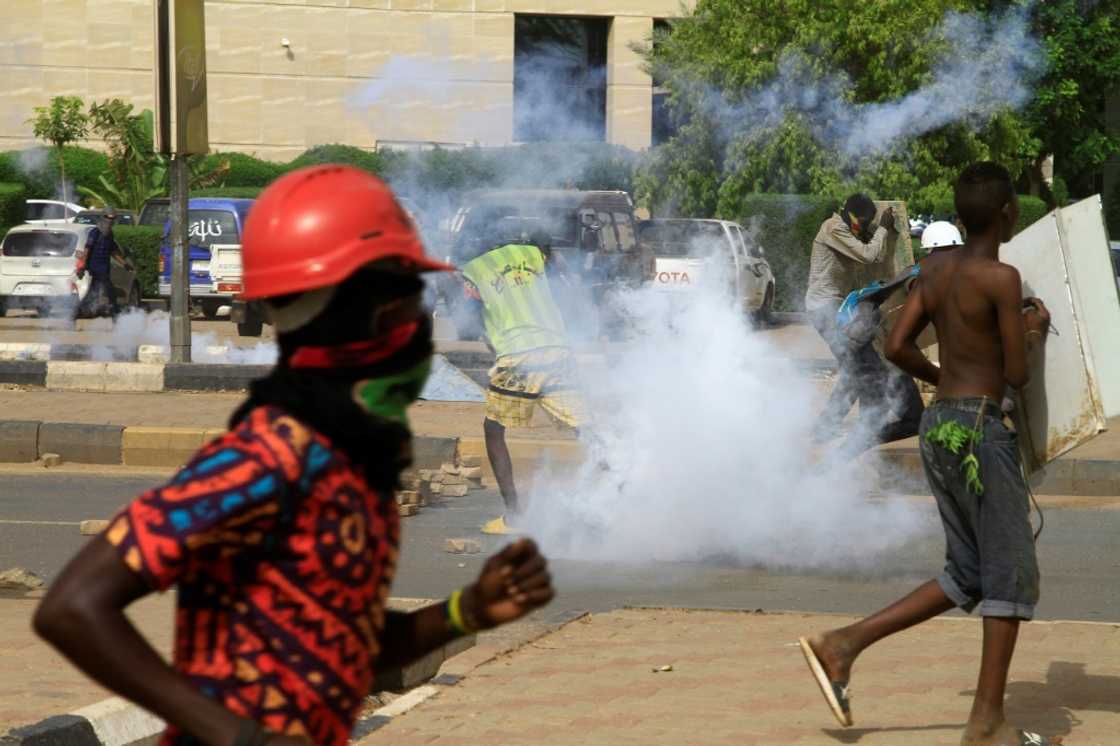 Youths run from tear gas fired by security forces as they protest in south Khartoum on August 31, 2022, to demand the return of civilian rule Youths run from tear gas fired by security forces as they protest in south Khartoum on August 31, 2022, to demand the return of civilian rule