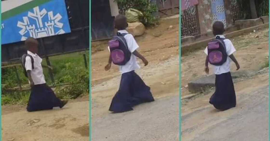 Primary school girl walks on the road in oversized uniform Primary school girl walks on the road in oversized uniform