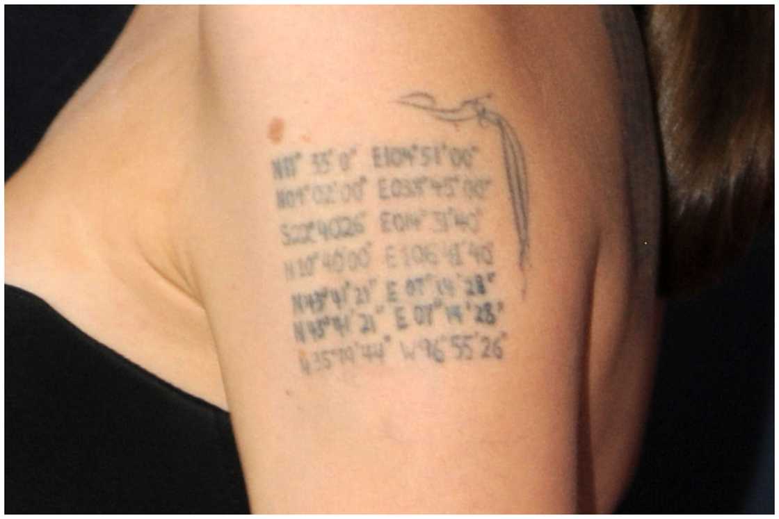Actress Angelina Jolie's coordinates tattoo on her upper arm during "The Normal Heart" New York Screening at Ziegfeld Theater in New York City. Actress Angelina Jolie's coordinates tattoo on her upper arm during "The Normal Heart" New York Screening at Ziegfeld Theater in New York City.