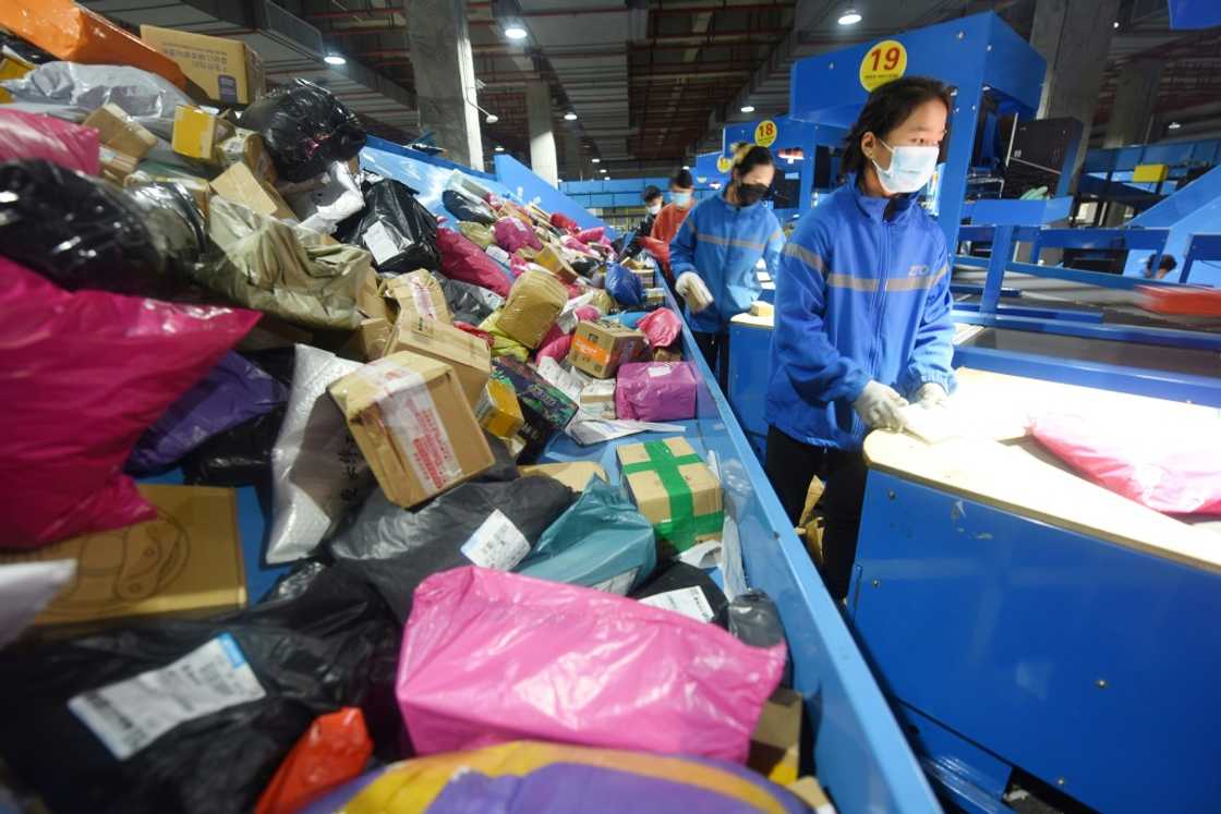 An employee sorts packages for delivery during the Singles Day shopping festival at a logistics center in Donghai, China