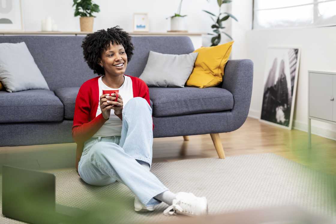 Serene young woman savoring a warm beverage Serene young woman savoring a warm beverage