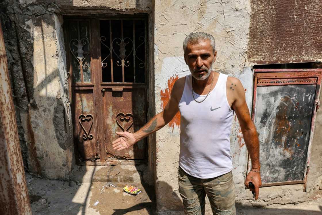 Najib al-Khatib, 52, indicates a place that was laden with corpses after the Sabra and Shatila massacre 40 years ago