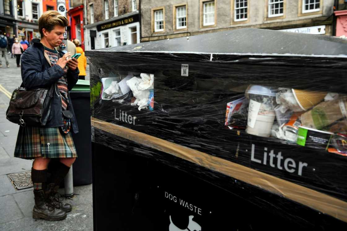 Bins have not been emptied, leaving rubbish overflowing and piled on the street Bins have not been emptied, leaving rubbish overflowing and piled on the street