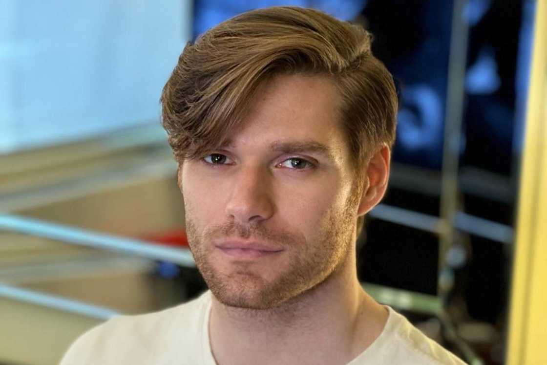 A man with a long side swept bang A man with a long side swept bang