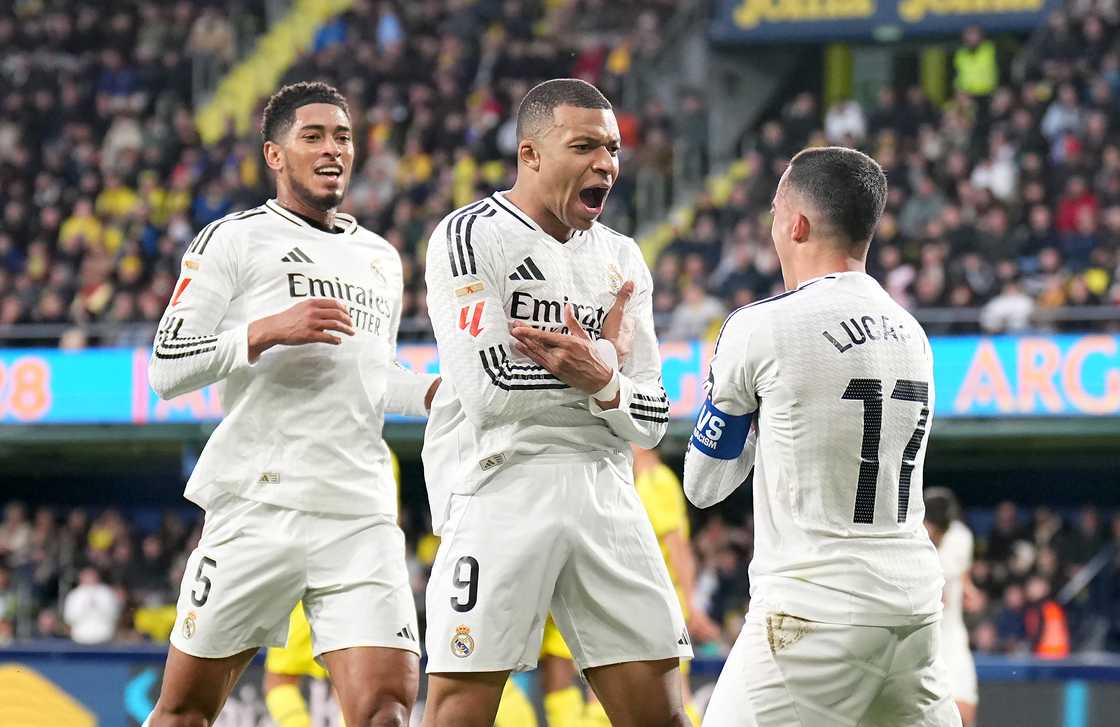 Kylian Mbappe of Real Madrid celebrates scoring his team's second goal with teammates Jude Bellingham and Lucas Vazquez during the LaLiga match between Villarreal CF and Real Madrid CF at Estadio de la Ceramica on March 15, 2025 in Villarreal, Spain Kylian Mbappe of Real Madrid celebrates scoring his team's second goal with teammates Jude Bellingham and Lucas Vazquez during the LaLiga match between Villarreal CF and Real Madrid CF at Estadio de la Ceramica on March 15, 2025 in Villarreal, Spain