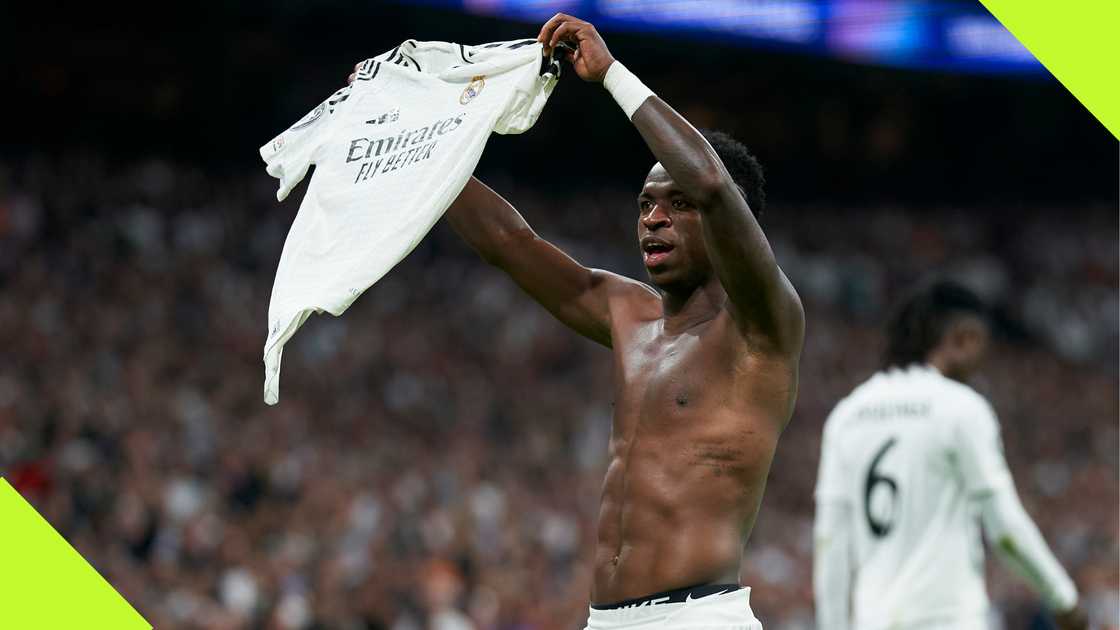 Brazilian winger Vinicius Junior hoists his jersey after completing his hat-trick during Real Madrid's 5-2 win against Borussia Dortmund.