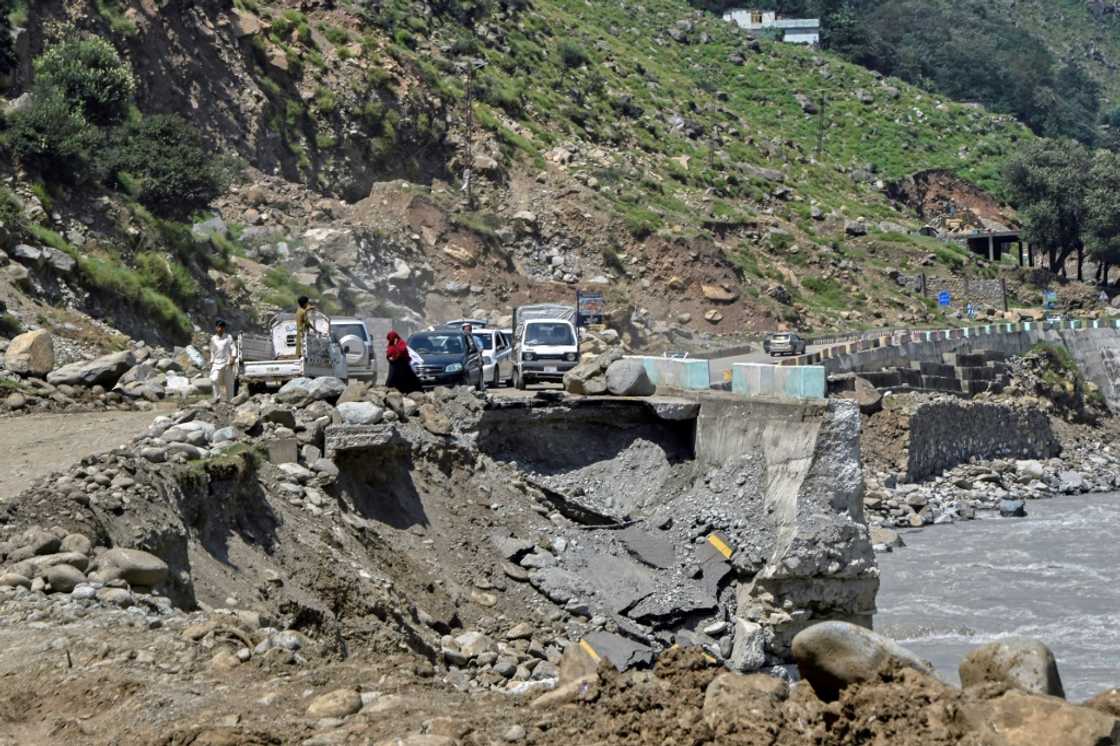 Vehicles wait to pass on a badly damaged road near Bahrain in Swat. The road ends short of the town after a flash flood destroyed its main bridge Vehicles wait to pass on a badly damaged road near Bahrain in Swat. The road ends short of the town after a flash flood destroyed its main bridge