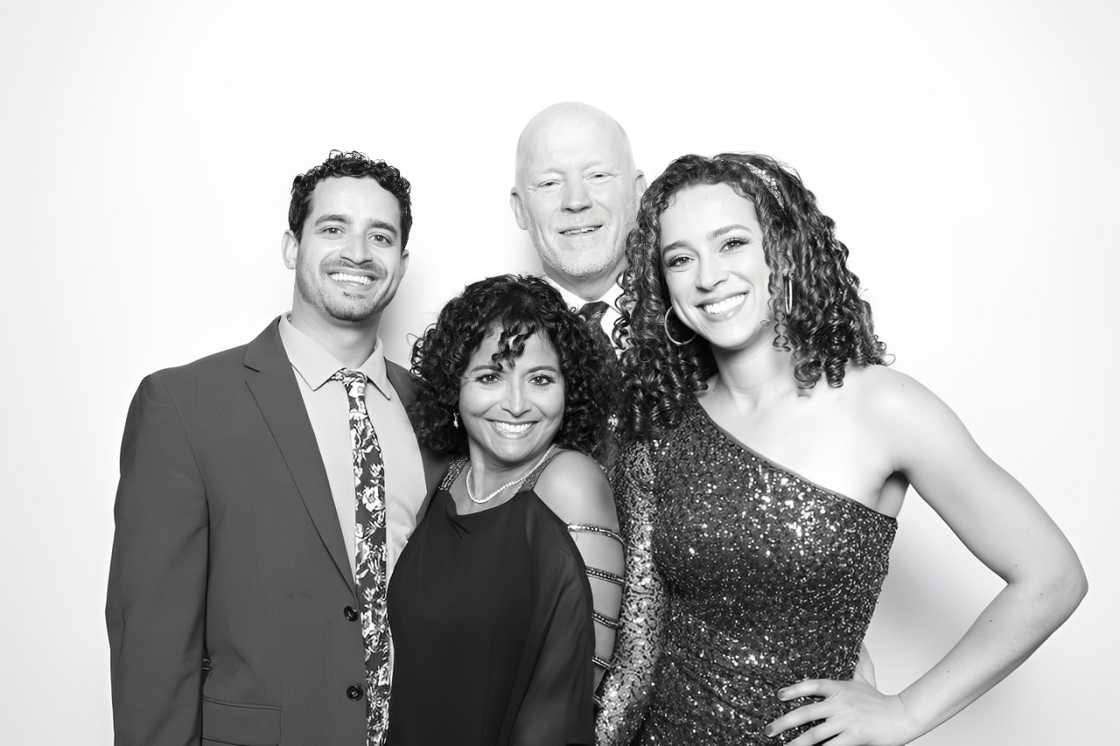 Madison Alworth with her parents and brother dressed formally in front of a white backdrop. Madison Alworth with her parents and brother dressed formally in front of a white backdrop.