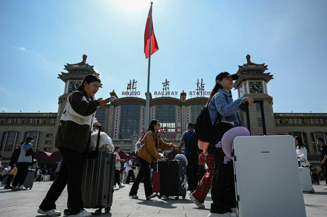 Travellers thronged China's transport networks as an eight-day national holiday kicked off Travellers thronged China's transport networks as an eight-day national holiday kicked off
