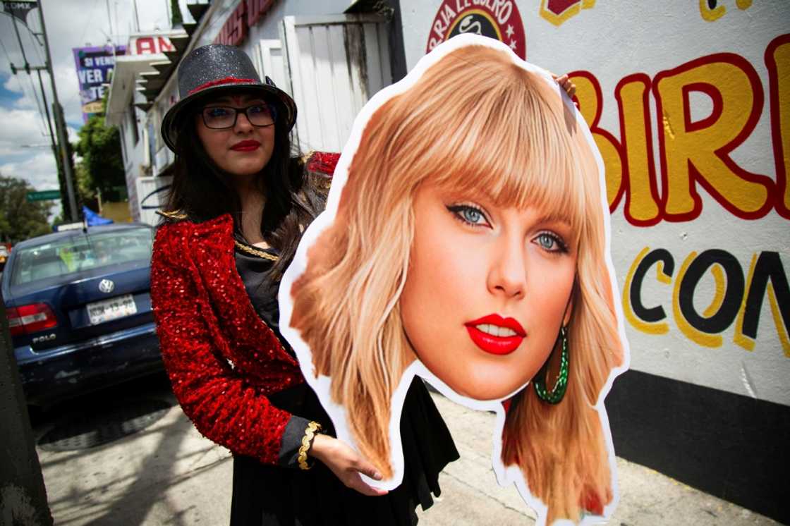 A fan of US superstar Taylor Swift holds a poster with the image of a singer before her presentation at the Foro Sol in Mexico City on August 24, 2023 A fan of US superstar Taylor Swift holds a poster with the image of a singer before her presentation at the Foro Sol in Mexico City on August 24, 2023