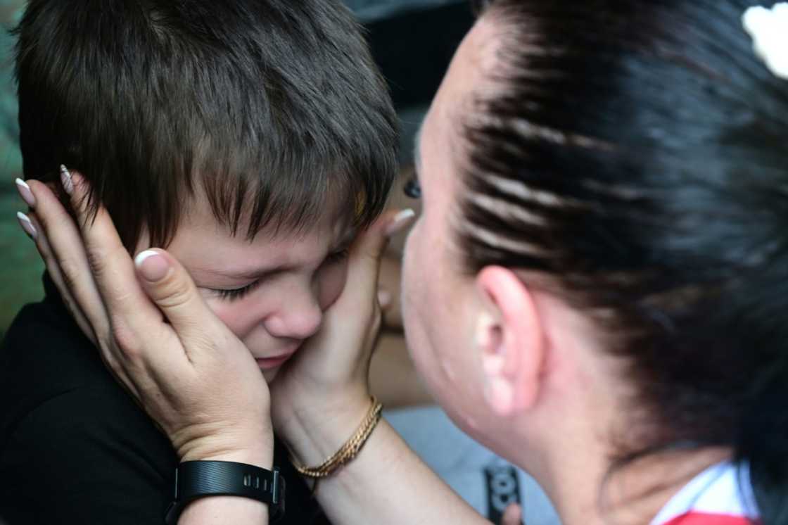 A woman says goodbye to her son before his evacuation from the city of Sloviansk on Wednesday A woman says goodbye to her son before his evacuation from the city of Sloviansk on Wednesday