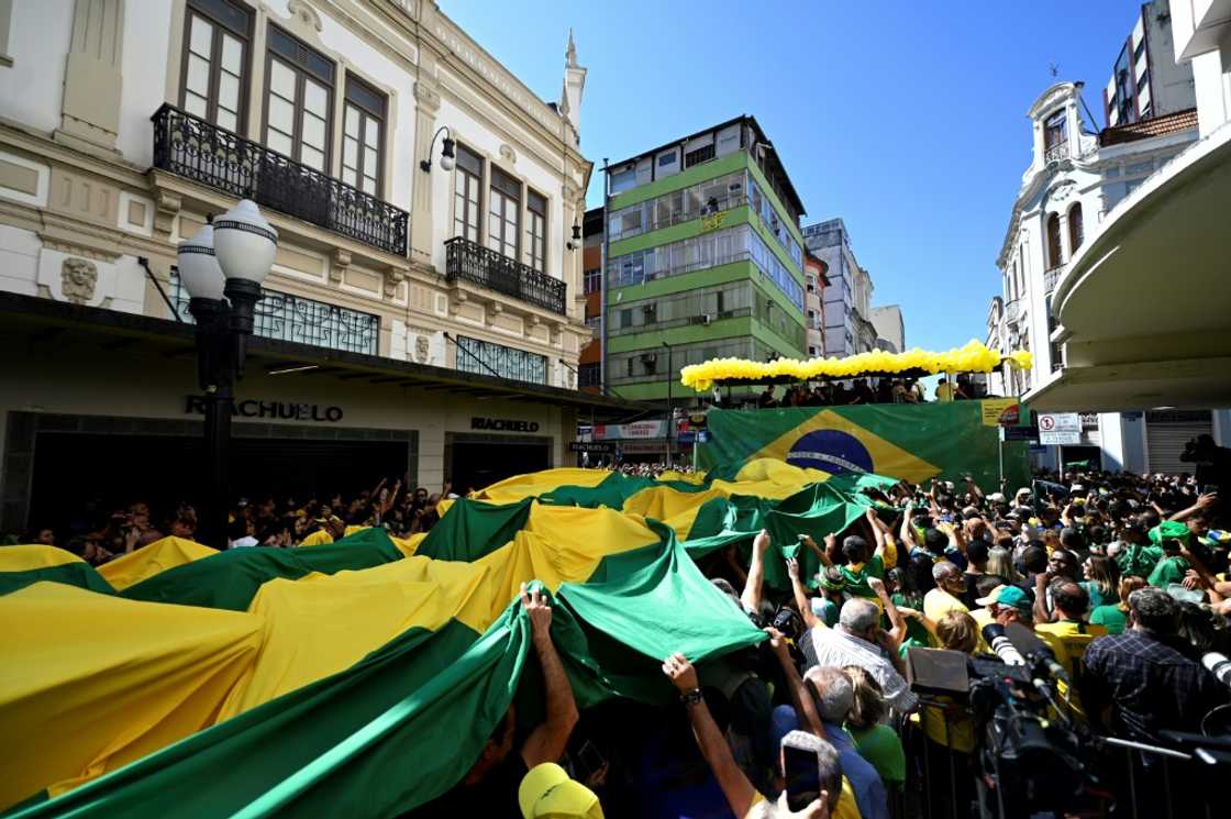 Supporters of Brazil's President Jair Bolsonaro celebrate the launch of the embattled far-right incumbent's bid for a second term in Juiz de Fora, in the state of Minas Gerais, Brazil, on August 16 2022 Supporters of Brazil's President Jair Bolsonaro celebrate the launch of the embattled far-right incumbent's bid for a second term in Juiz de Fora, in the state of Minas Gerais, Brazil, on August 16 2022