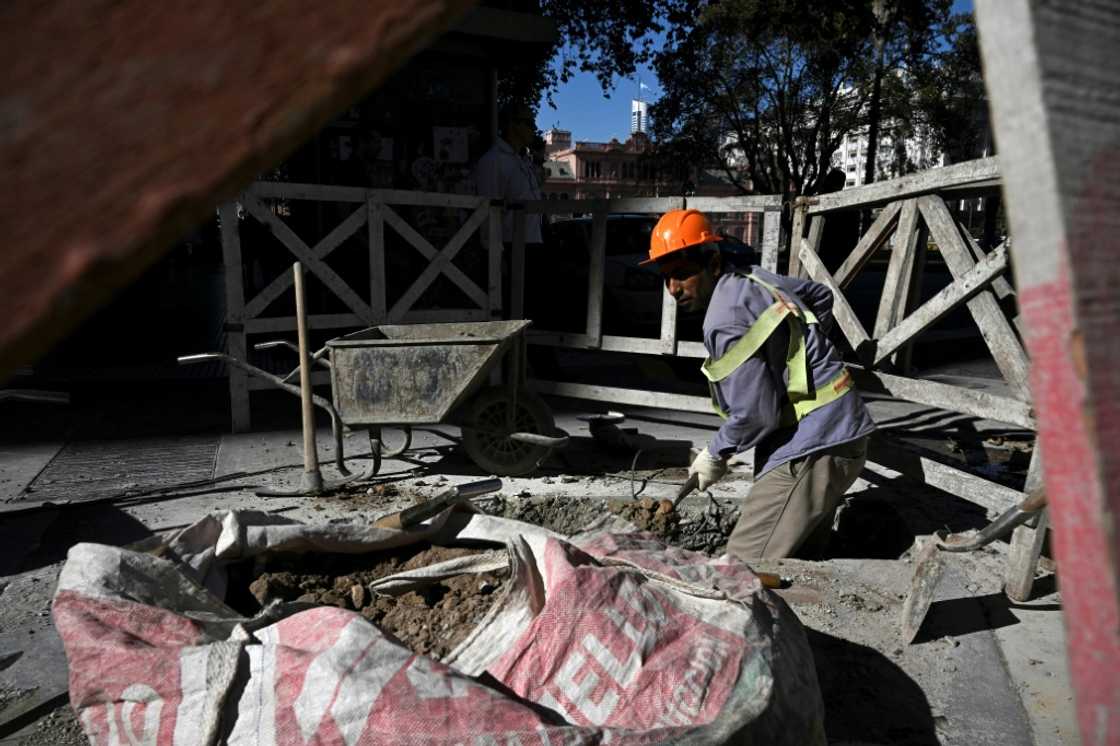 A man works on a street in Buenos Aires, where residents are dealing with soaring inflation. The cost of living in Argentina has risen by 31 percent since January 1. Last year, more than 39 percent of the population was living in poverty