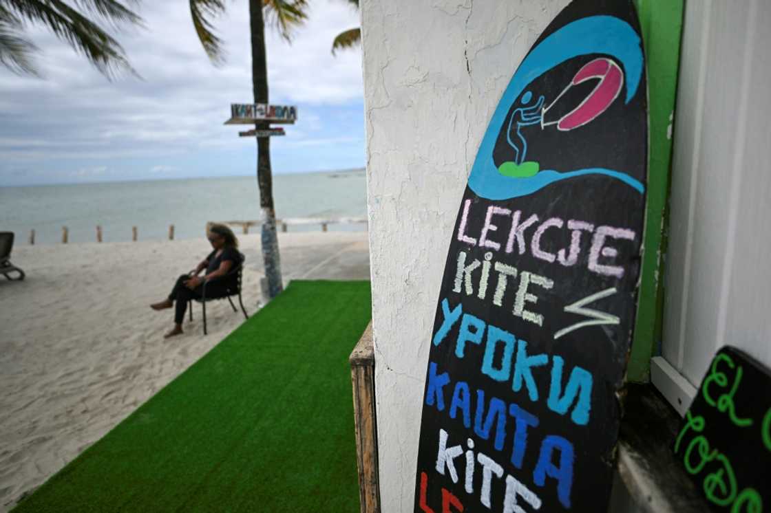 Islanders are making efforts to appeal to tourists from other places -- such as with this kitesurfing sign, written in Russian Islanders are making efforts to appeal to tourists from other places -- such as with this kitesurfing sign, written in Russian