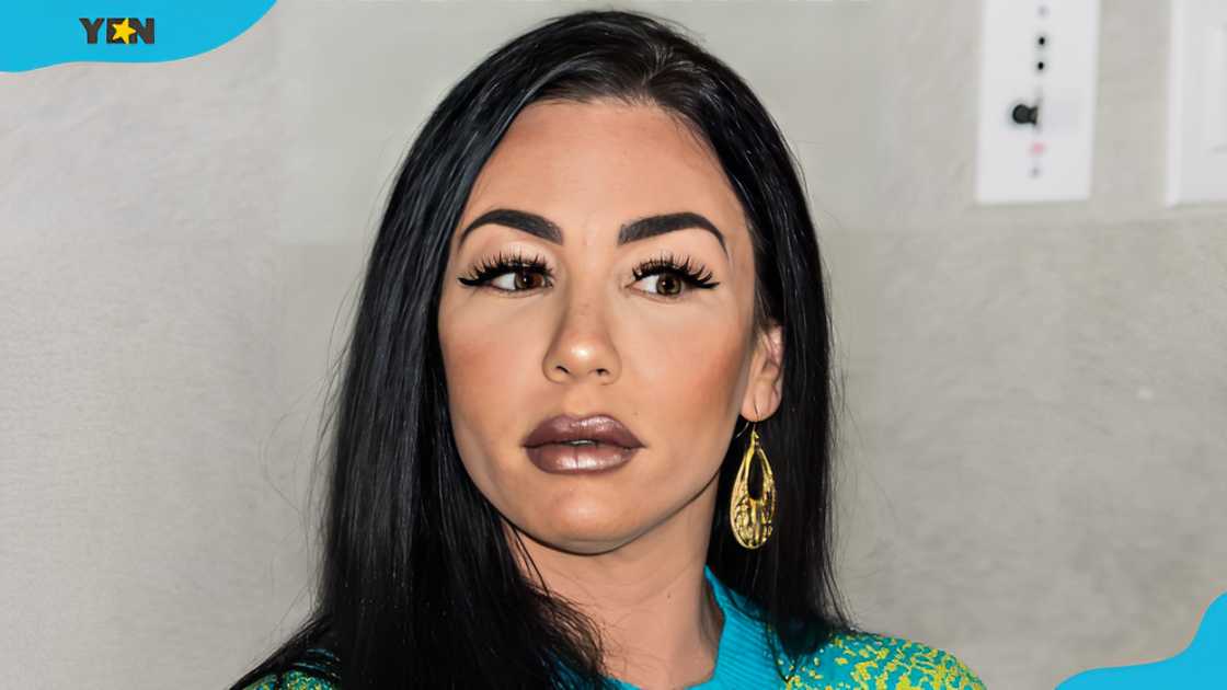 Natalie DiDonato posing for a pic in a side part hairstyle