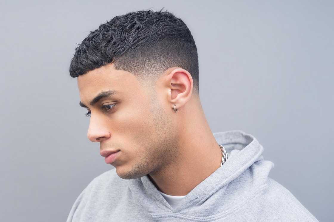 A man with a grey hood is rocking a tapered french crop A man with a grey hood is rocking a tapered french crop