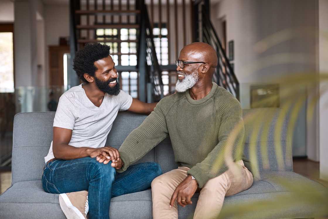 A young man is relaxing and spending time with his father A young man is relaxing and spending time with his father