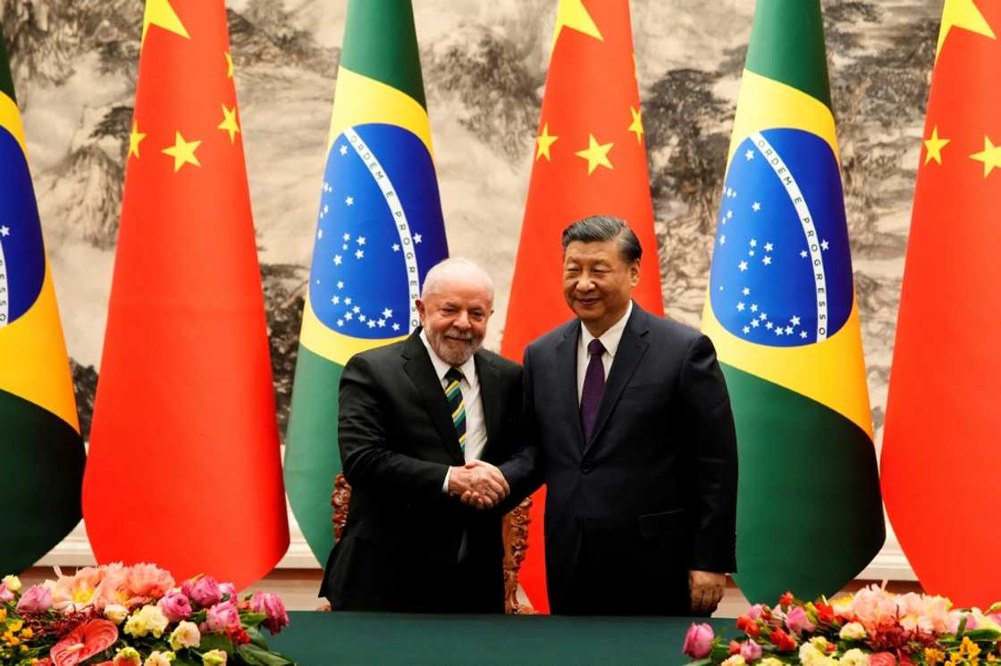 Chinese President Xi Jinping (R) and Brazil's President Luiz Inacio Lula da Silva shake hands after a signing ceremony at the Great Hall of the People in Beijing Chinese President Xi Jinping (R) and Brazil's President Luiz Inacio Lula da Silva shake hands after a signing ceremony at the Great Hall of the People in Beijing