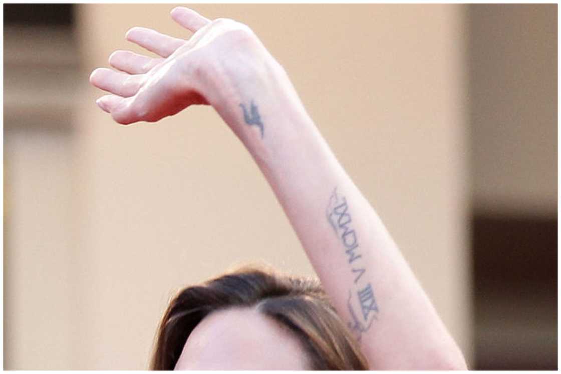 Actress Angelina Jolie's letter h tattoo is seen as she attends "The Tree Of Life" premiere during the 64th Annual Cannes Film Festival at Palais des Festivals in Cannes, France. Actress Angelina Jolie's letter h tattoo is seen as she attends "The Tree Of Life" premiere during the 64th Annual Cannes Film Festival at Palais des Festivals in Cannes, France.