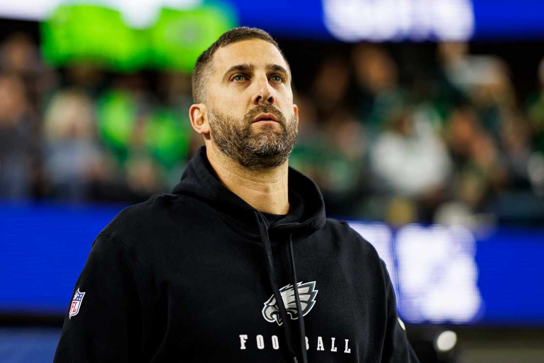 Nick Sirianni stands on the field before an NFL football game against the Los Angeles Rams