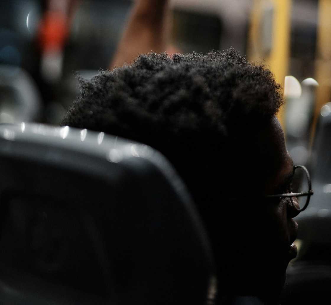 A young student talking to someone in a bus A young student talking to someone in a bus
