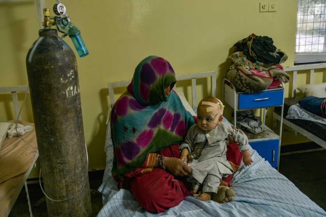 A woman cradles an injured child at the Sharan Hospital in Paktika province A woman cradles an injured child at the Sharan Hospital in Paktika province