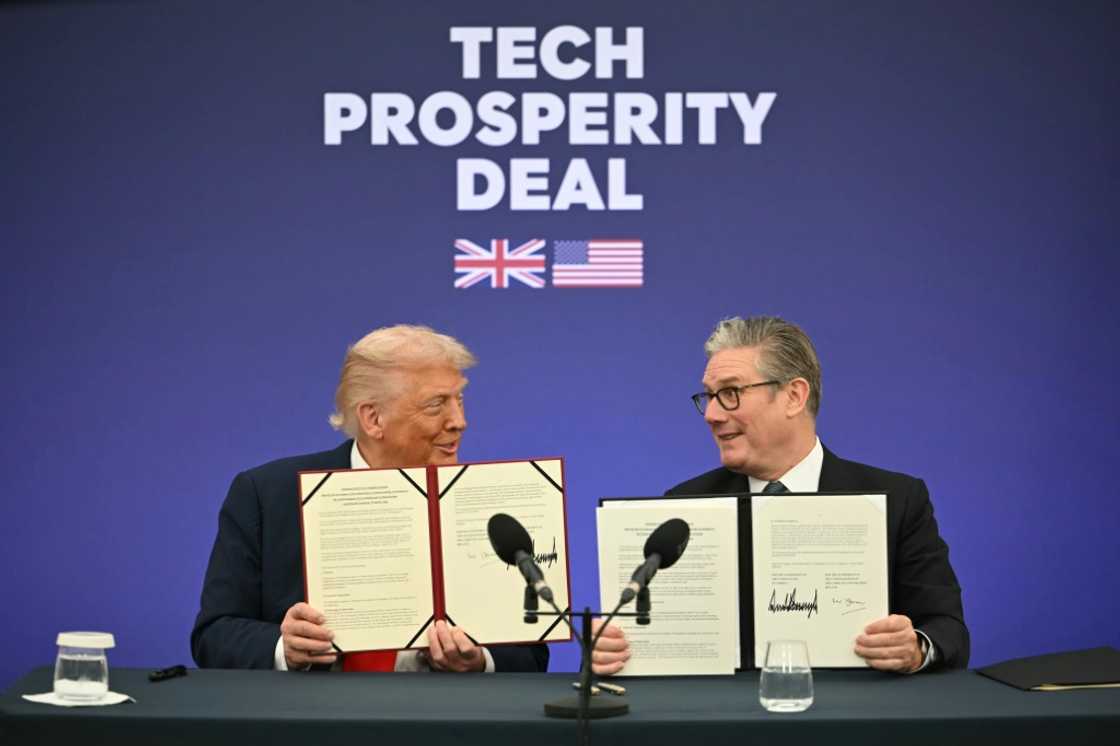 Britain's Prime Minister Keir Starmer (R) and US President Donald Trump (L) show off their signed technology deal at a business event at Chequers Britain's Prime Minister Keir Starmer (R) and US President Donald Trump (L) show off their signed technology deal at a business event at Chequers