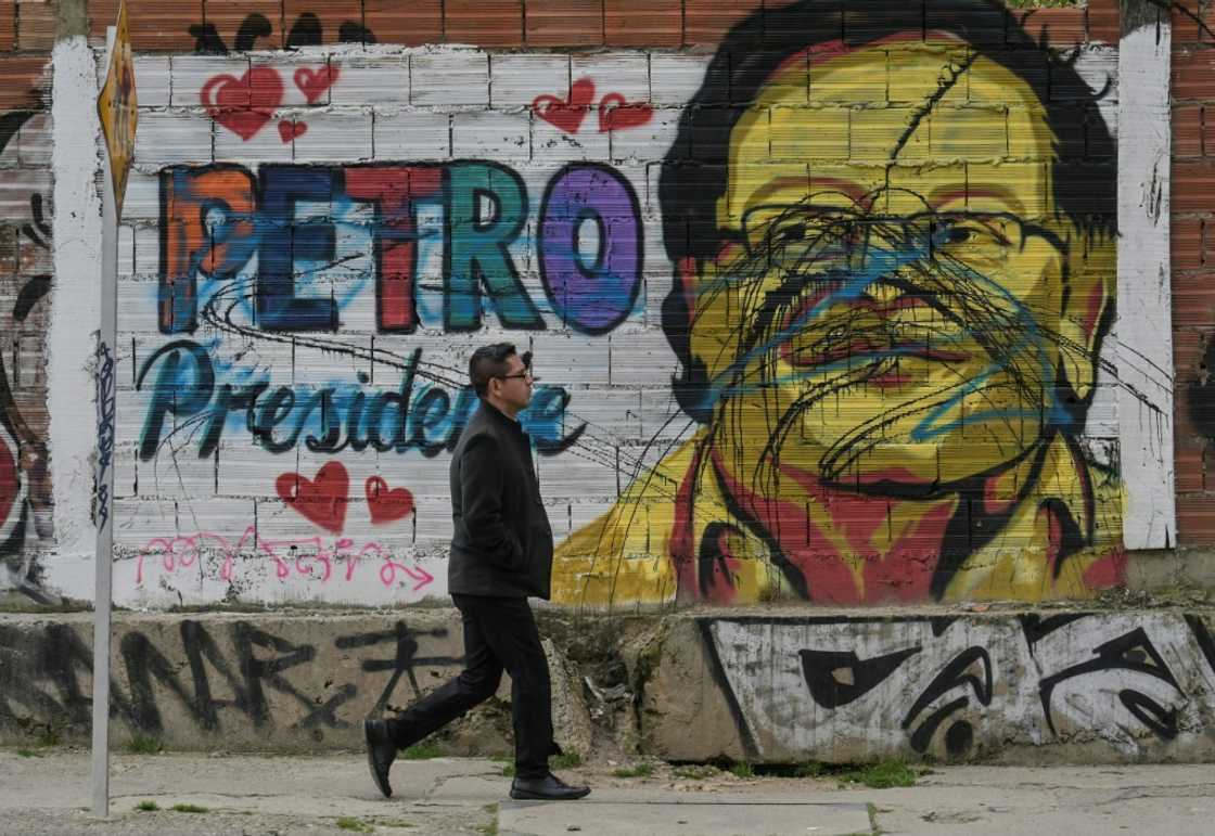 A man walks past a mural depicting Colombian left-wing presidential candidate Gustavo Petro in Bogota on June 16, 2022, ahead of the weekend's presidential runoff election A man walks past a mural depicting Colombian left-wing presidential candidate Gustavo Petro in Bogota on June 16, 2022, ahead of the weekend's presidential runoff election