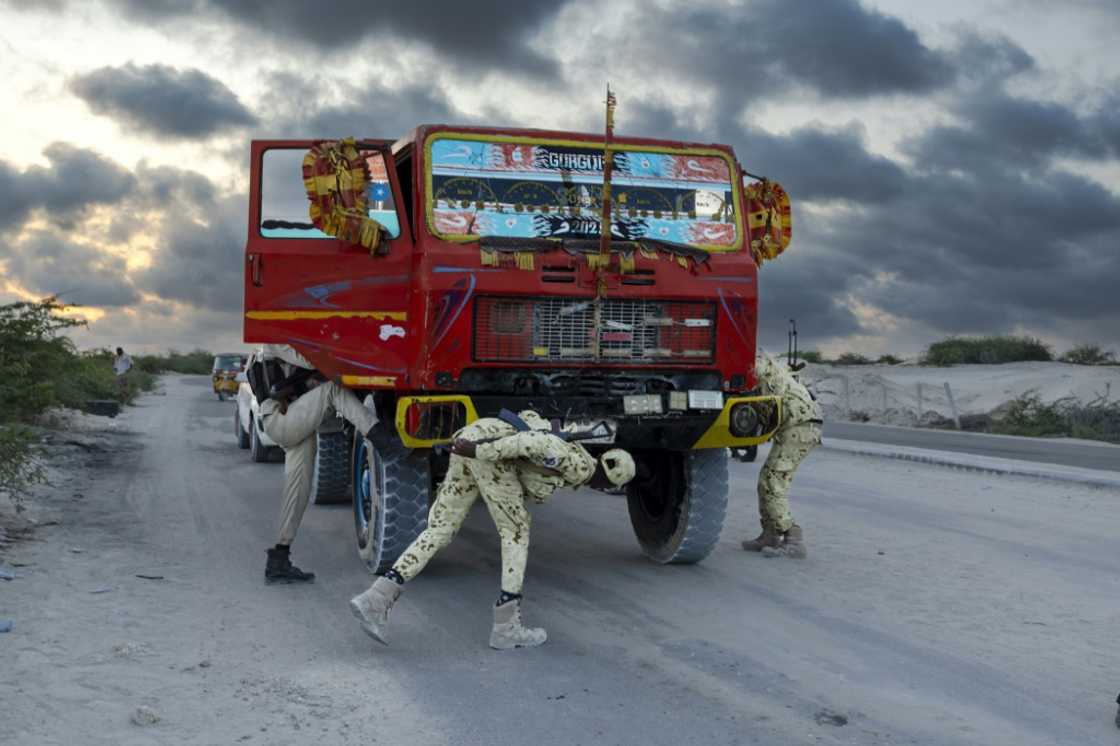 Vehicles are carefully checked by security forces to prevent attacks Vehicles are carefully checked by security forces to prevent attacks