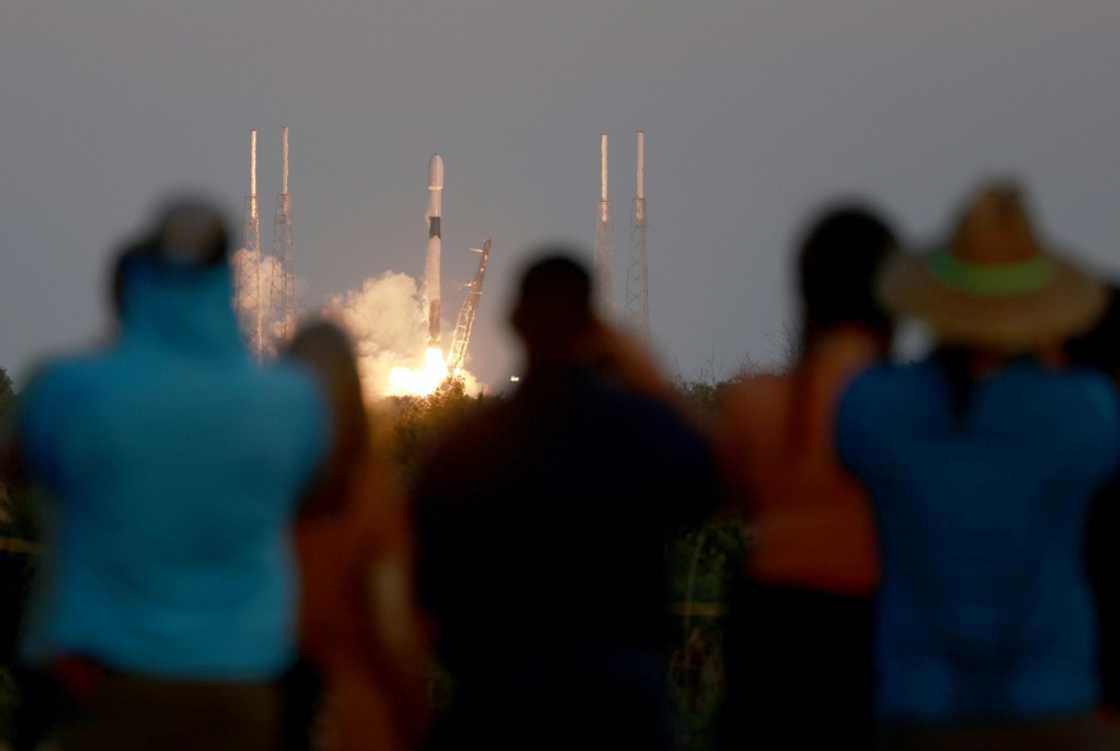 People watch as a SpaceX Falcon 9 rocket lifts off at Cape Canaveral Space Force Station on February 27, 2023 People watch as a SpaceX Falcon 9 rocket lifts off at Cape Canaveral Space Force Station on February 27, 2023