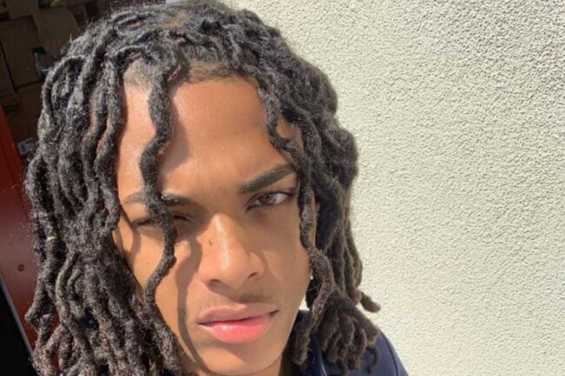 An young man rocks a wavy dreadlocks style An young man rocks a wavy dreadlocks style