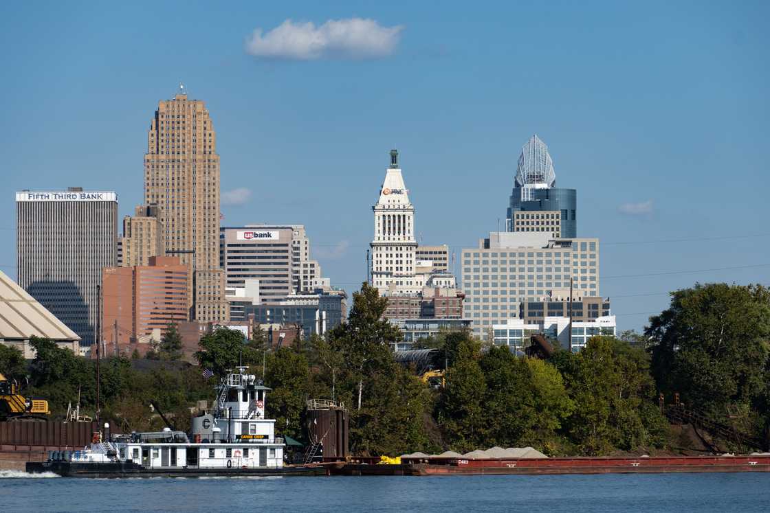 Barge transporting gravel up the Ohio River. Cincinnati skyline in the background