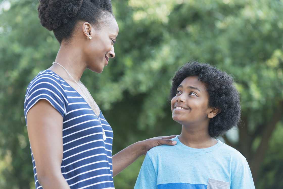 A mother and son looking at each other, smiling