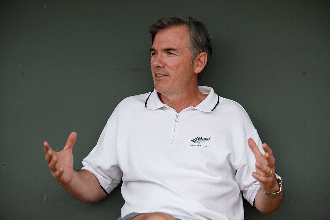 Billy Beane of the Oakland Athletics relaxes in the dugout